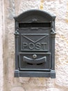 Old metal mailbox on a stone wall - close up. Royalty Free Stock Photo