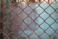 Old metal mesh wire fence with blur background Royalty Free Stock Photo