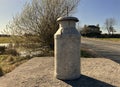 Old milk churn, still waiting to be collected, on a late summers day in, Allerton, Bradford, UK Royalty Free Stock Photo