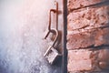 An old metal open lock hangs on the handle of an iron door, standing in a brick building. An open secret Royalty Free Stock Photo