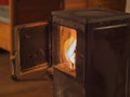 Old metal open stove door with burning flame wood