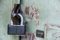 Old metal padlock on old painted wooden door Royalty Free Stock Photo