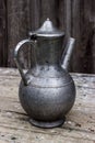 Old metal pitcher on a table Royalty Free Stock Photo
