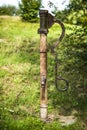 Old metal pump water in a garden summer time Royalty Free Stock Photo