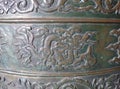 Old metal relief - probably bronze - in buddhist temple of Ninh Royalty Free Stock Photo