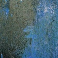 Old metal rusted wall partly covered with peeling paint. Grunge texture and background. Close-up Royalty Free Stock Photo