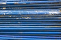 Old metal rusty blue construction pipes in a heap. rough surface texture Royalty Free Stock Photo