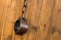 Old metal shackles closed with a chain of rings hanging on a wooden wall background Royalty Free Stock Photo