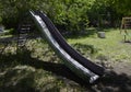 Old metal slide for children riding. Royalty Free Stock Photo
