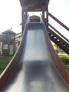 old metal slide on a children& x27;s playground in a country Royalty Free Stock Photo