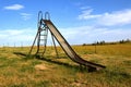 Old slippery-slide remains in a rural playground setting Royalty Free Stock Photo
