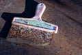 Old metal spatula with a plastic handle on a rusty sheet of metal, close-up, selective focus Royalty Free Stock Photo