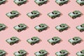 Old metal sport car toy green color on pink background. Minimal design. Pattern