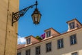 The old, metal, street lamps mounted on colorful tiled buildings in Lisbon, Portugal Royalty Free Stock Photo