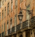 The old, metal, street lamps mounted on colorful tiled buildings in Lisbon, Portugal Royalty Free Stock Photo