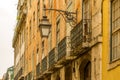 The old, metal, street lamps mounted on colorful tiled buildings in Lisbon, Portugal Royalty Free Stock Photo