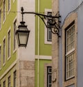 The old, metal, street lamps mounted on colorful tiled buildings in Lisbon, Portugal Royalty Free Stock Photo