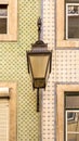 The old, metal, street lamps mounted on colorful tiled buildings in Lisbon, Portugal Royalty Free Stock Photo