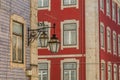 The old, metal, street lamps mounted on colorful tiled buildings in Lisbon, Portugal Royalty Free Stock Photo