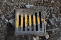 Old metal street manhole cover painted with yellow paint. Road reconstruction. Sewer hatch.