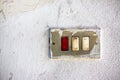 Old metal switch against a white plaster wall Royalty Free Stock Photo