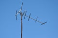 Old metal TV antenna against blue sky Royalty Free Stock Photo
