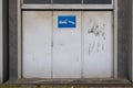 Old metal warehouse door, hangar with tow away sign Royalty Free Stock Photo