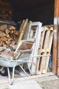 Old metal wheelbarrow with firewood Royalty Free Stock Photo