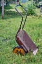 Old metal wheelbarrow for transportation of different cargoes