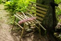 Old metal and wooden cemetery bench with rakes on it