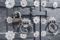 The old metal wrought-iron door is locked with a padlock. Closed metal lock. Royalty Free Stock Photo