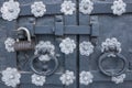 The old metal wrought-iron door is locked with a padlock. Closed metal lock. Royalty Free Stock Photo