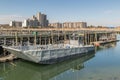 Old metallic ferry boat docked at old wooden pier