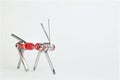 Old metallic red bike multi-tool is going to fix, repair and service on a white background. Animal robot for bike help Royalty Free Stock Photo