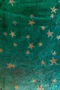 Old metallic texture with colorful stars.