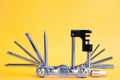 Old metallic bike multi tool set with chain remover on a yellow background. Bicycle multifunction hand tool Royalty Free Stock Photo
