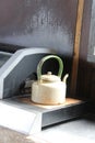 Old metallic yellow colored kettle placed on a counter