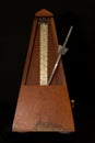 Old metronome with black background Royalty Free Stock Photo