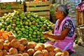 Old mexican woman selling fruits at market