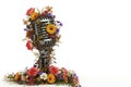 An old microphone decorated with flowers and branches. Space for text. Royalty Free Stock Photo