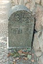 Old milestone on cobblestone road in Portugal