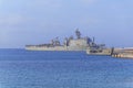 Old military battleship with radar on blue sea docked at marina Royalty Free Stock Photo