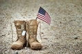 Old military combat boots with dog tags and a small American flag Royalty Free Stock Photo