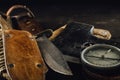 Old military compass, rusty hunting bushcraft knife, and small axe on the dark wooden table. Royalty Free Stock Photo