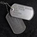 Close up of old and worn military dog tags Royalty Free Stock Photo