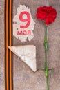 old military letters with carnations, St. George ribbon and inscription on May 9 on a scrap of leaf