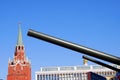 Old military machine barrels and Moscow Kremlin tower.