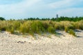 Old military observation tower on the beach of Hel, Poland. Sandy beach with green and yellow grass on a beautiful