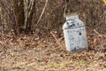 Old milk can laying in wooded area. Royalty Free Stock Photo