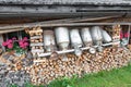 Old milk cans and firewood in alpine hut Royalty Free Stock Photo